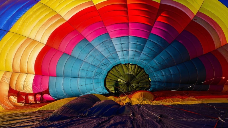 burning, pattern, inflating, transportation, travel, outdoors, mode of transportation, balloon, hot air balloons, day, air vehicle, hot air balloon, incidental people