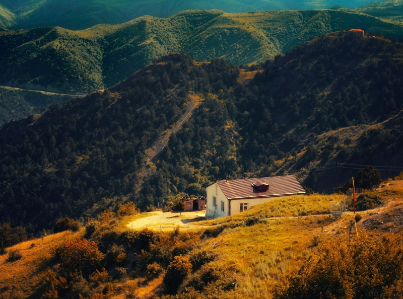 building, non-urban scene, armenia, tree, Mountains, building exterior, tranquility, beauty in nature, mountain, day, architecture, mountain peak, tranquil scene