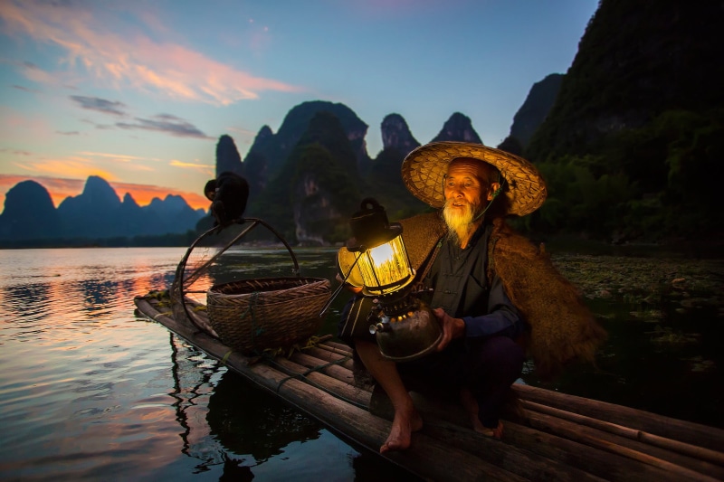 water, sunset, 1080P, boat, beauty in nature, China, bird, one person, sky, clothing, wood - material, women, mountain, district Guangxi Joins, real people