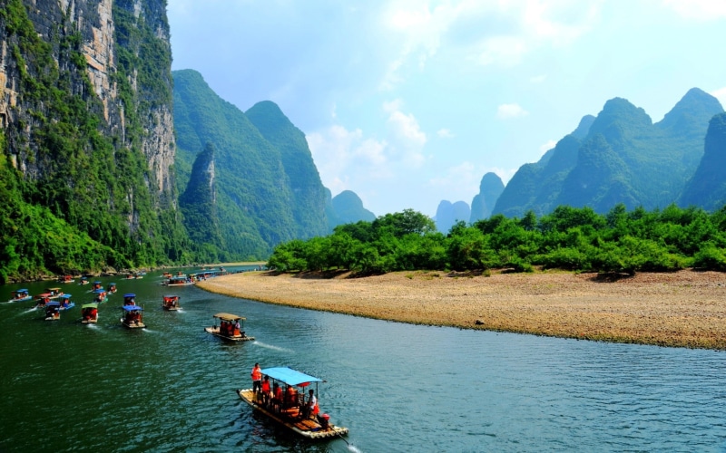 sky, beauty in nature, nature, water, landscape, Li River, day, mountain range, group of people, travel, outdoors, nautical vessel, non-urban scene, mountain