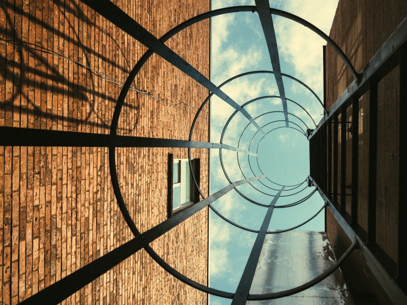 worm, s, spiral, shape, sunlight, boundary, exit, design, eye, shadow, fence, day, cage, lookup, yorkville, outdoors, photo, metal, architecture, bricks