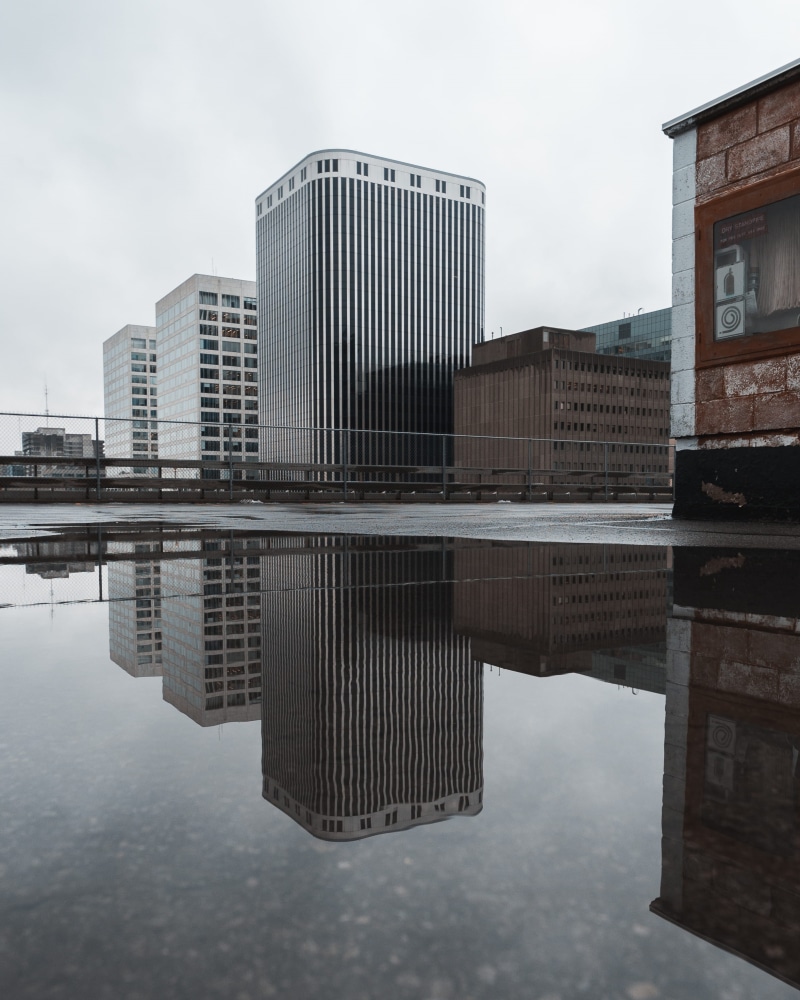 office building exterior, modern, lake, near, buildings, reflecting pool, no people, gray, financial district, nature, waterfront, rise, reflection, 2K