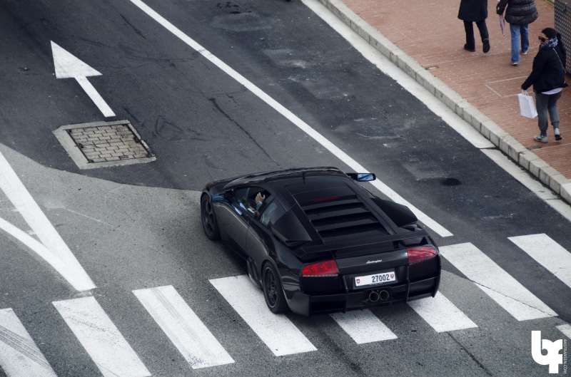 land vehicle, motor vehicle, city, street, road, sign, day, marking, road marking, mode of transportation, crosswalk, Lamborghini Murcielago, Lamborghini