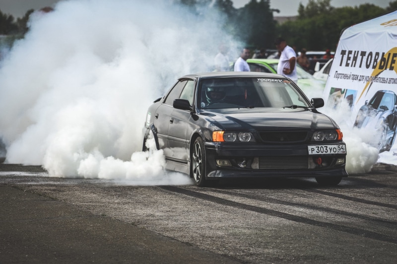 misfortune, outdoors, city, driving, land Vehicle, competition, on the move, sport, chaser, public transportation, side view, street, car, smoke - Physical Structure