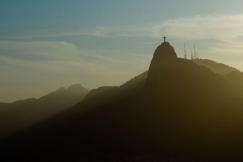 sunrise, spire, belief, mountain peak, dome, travel, peak, sugarloaf mountain, sky, building exterior, cross, no people, built structure, scenery, daytime