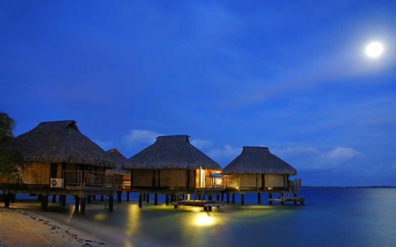 nature, sea, resort, house, sky, tranquility, night, beach, roof, built structure, tranquil scene, sand, outdoors, 480P, bungalow, lights, water, no people