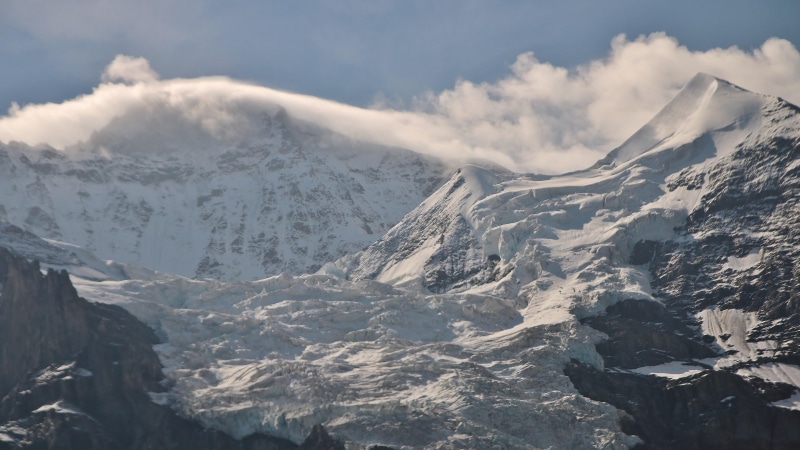 tranquil scene, cloud - sky, mountainous landforms, environment, snowcapped mountain, summit, tranquility, range, mountain, beauty in nature, outdoors
