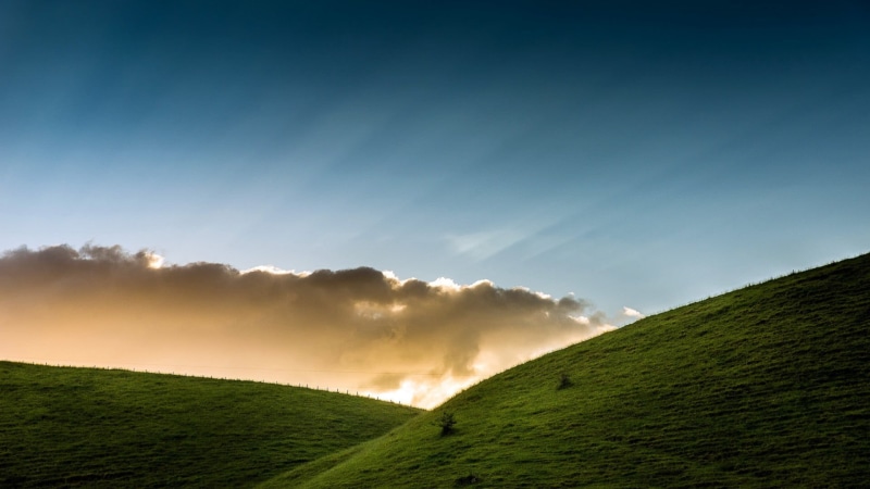 outdoors, clouds, rolling landscape, sky, tranquil scene, hill, landscape, land, non-urban scene, sun rays, cloud - sky, calm, field, rural scene, scenics - nature