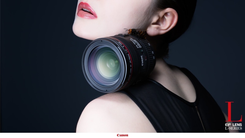 studio shot, camera, commercial, women, black background, indoors, human body part, black, headshot, lens - eye, camera - photographic equipment, one person