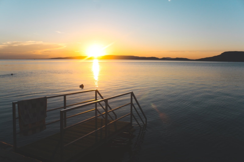 water, cloud - sky, orange color, sky, brown, beauty in nature, outdoors, Lake Balaton, sun, no people, nature, mountains, tranquility, non-urban scene