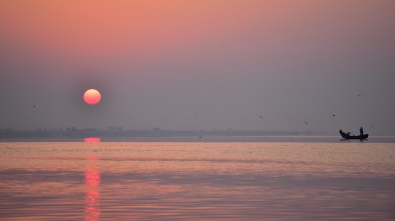 water, fisherman, reflection, outdoors, sunset, mode of transportation, fishing, tranquility, travel, full moon, tranquil scene, sun, scenics - nature