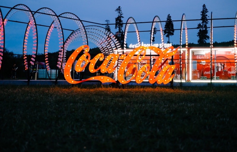 lights, nature, security, cola, trees, fence, night, architecture, red, leisure activity, sky, festival, coca, boundary, orange color, field, land, botles