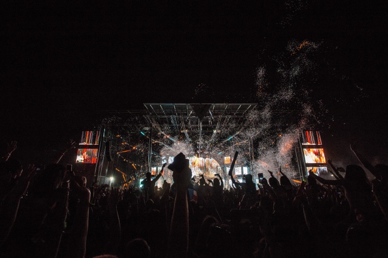festival, building exterior, stage, built structure, arts culture and entertainment, night, lights, motion, performance, entertainment, real people, fun