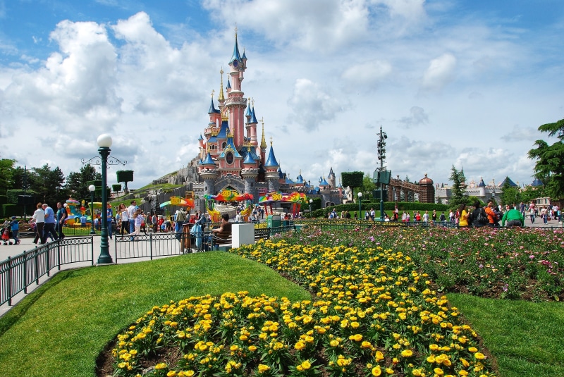 large group of people, travel destinations, building exterior, flowerbed, real people, architecture, sky, paris, nature, castle, tower, built structure