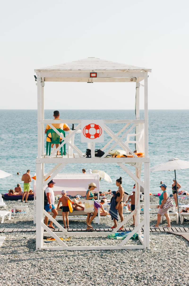 beach, 4K, daylight, seashore, swimming, real people, lifestyles, water, large group of people, lifeguard tower, adult, men, near, women, sand, chairs