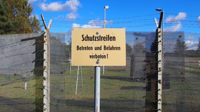 protection, cold war, barbed wire, sky, outdoors, border, sign, text, cloud - sky, former gdr border, day, safety, western script, communication, boundary