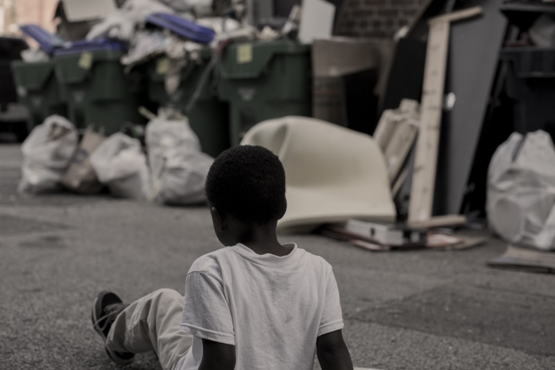 lonely, garbage, rear view, united states, city, young kid, casual clothing, trash bag, alley, 5K, full length, dirty, waiting, one person, building, summer