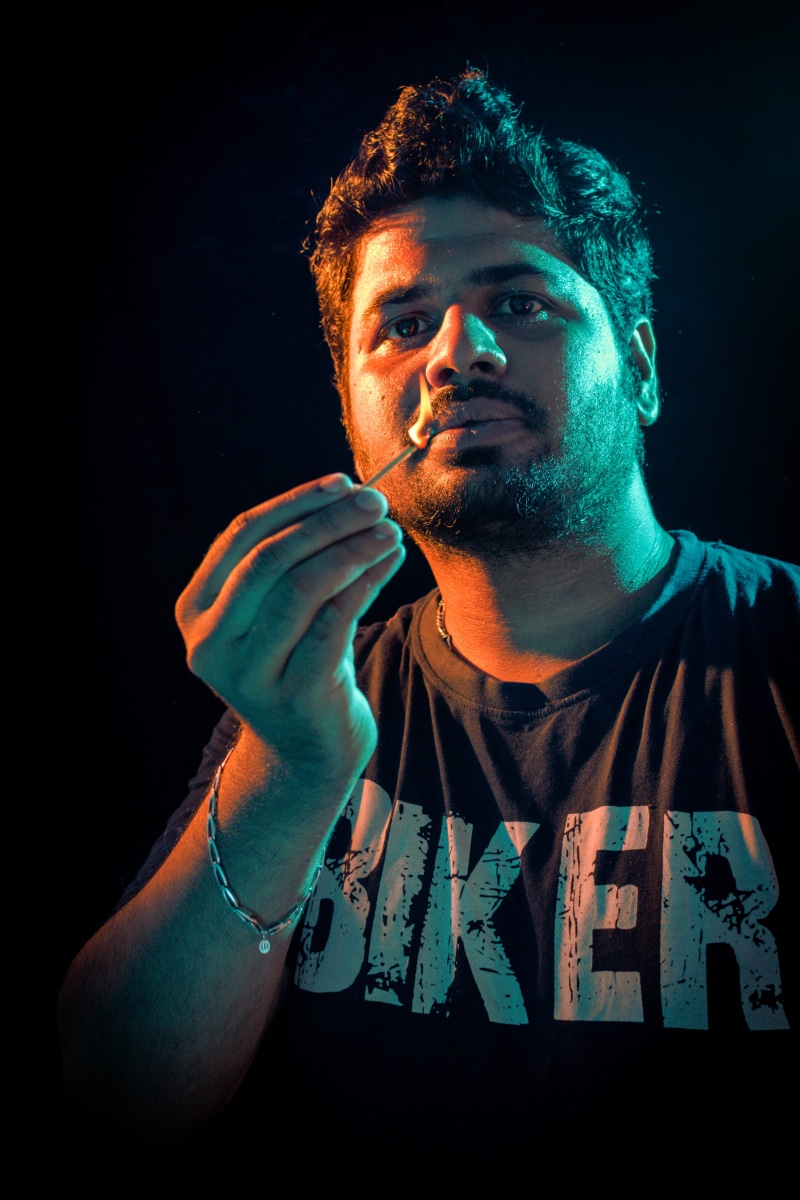 singer, flashphotography, 4K, facial hair, emotion, dark, lightbeam, performance, modern, stagelight, beard, india, indoors, front view, looking, gig