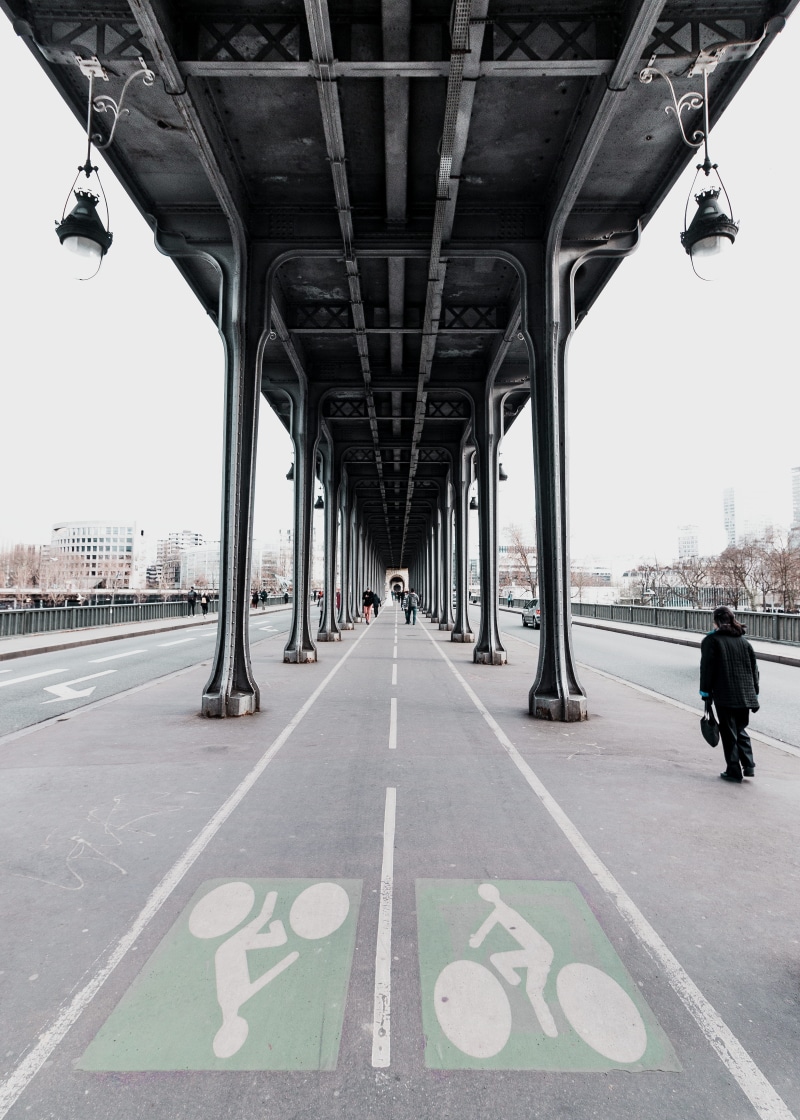 bridge - man made structure, architecture, daytime, sign, street, bicycle, built structure, person, walking, tunnel, beside, day, architectural column