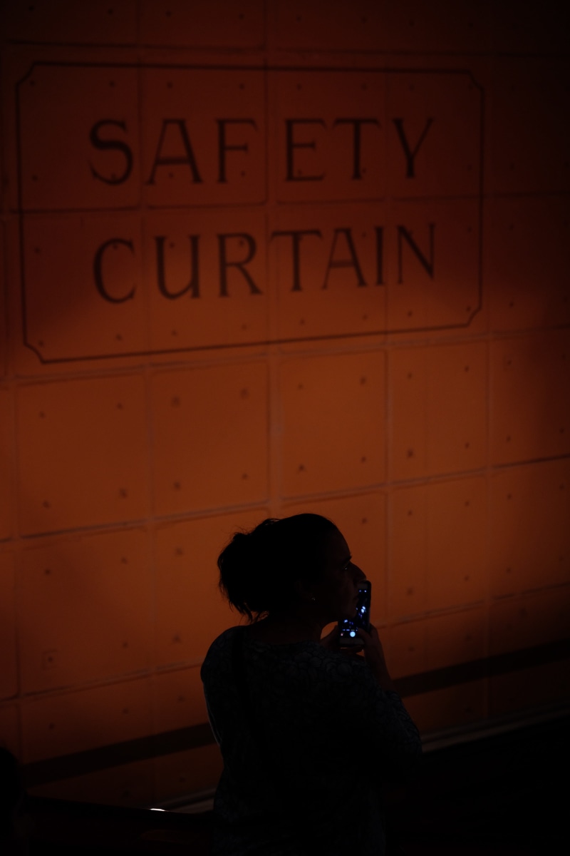 wall - building feature, phantom, lighting, one person, picture, the, text, safety, curtain, night, real people, western script, 5K, phantom of the opera