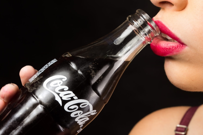 woman, one person, beautiful woman, hand, human face, glass bottle, drinking, human lips, 4K, food and drink, black background, coca cola, bottle, body part