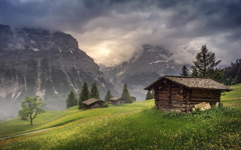 building, land, grass, Switzerland, plant, mountain range, chalet, hut, cloud - sky, built structure, environment, tranquil scene, outdoors, mountain, rural scene