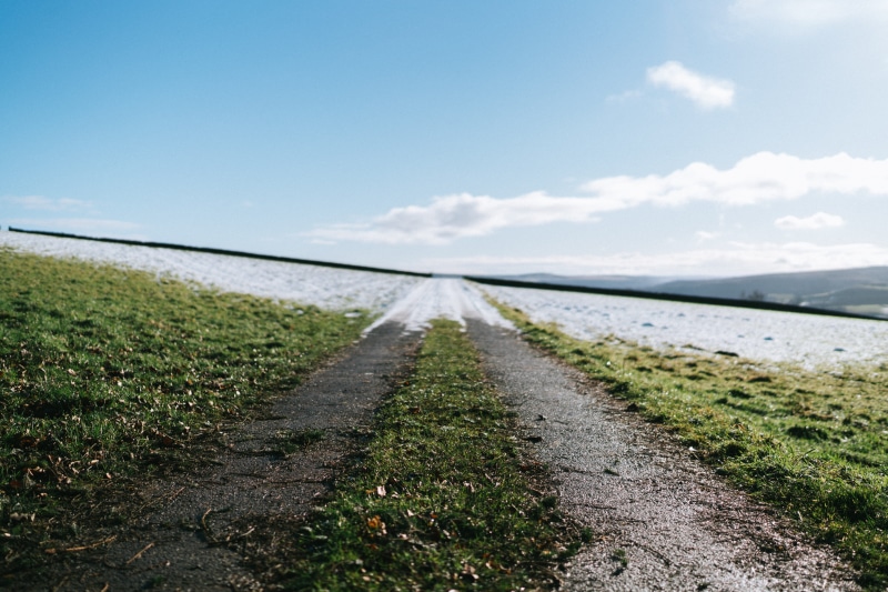 sun, season, the way forward, depth of field, winter, cloud - sky, mountaintravel, field, no people, tranquil scene, dof, transport, grass, diminishing perspective
