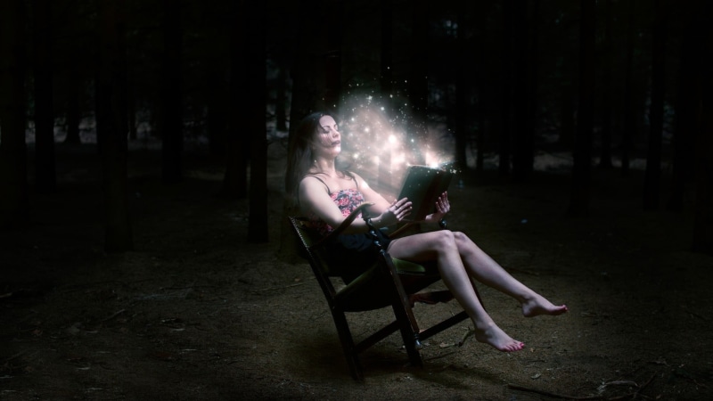 open mouth, nature, dark, trees, leisure activity, wireless technology, sitting, brunette, magic, young women, glowing, real people, barefoot, holding