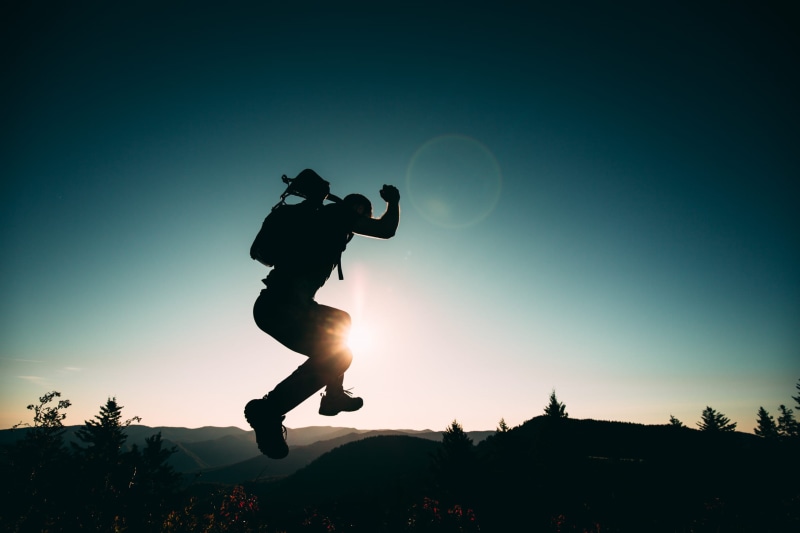 side view, hike, male, adventure, sunlight, mountain ridge, sky, guy, leisure activity, blue, one person, motion, 1080P, plant, leap, real people, hill