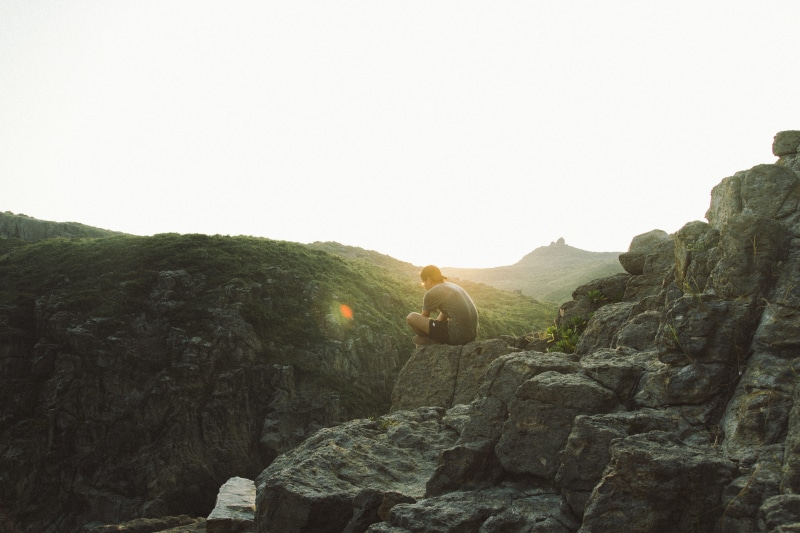 5K, person, day, tranquil scene, rock, sitting, sunrise, cliff, sittin, outdoors, male, clear sky, scenics - nature, sky, alone, rock formation, edge