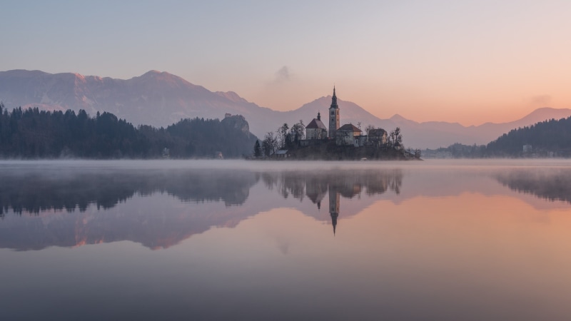 old building, Slovenia, dusk, sunset, 1080P, pine trees, mountains, outdoors, island, lake, sky, mist, river, forest, dawn, water, Lake Bled, reflection