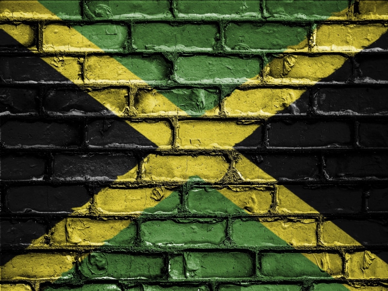 full frame, flag, brick wall, architecture, multi colored, close-up, wall - building feature, textured, patriot, bricks, patriotism, jamaica, yellow, graffiti