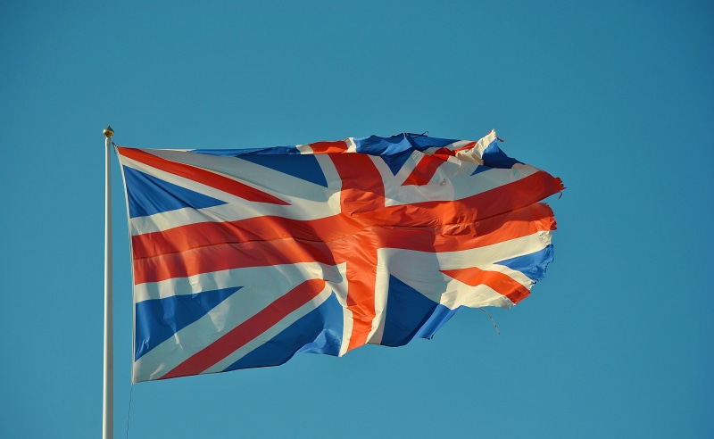 outdoors, day, sunlight, sky, motion, independence, red, pole, english, freedom, kingdom, sunny, low angle view, environment, london, clear sky, blue, symbol