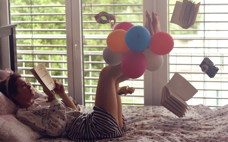 leisure activity, toys, women, day, furniture, lying down, bed, multi colored, home interior, indoors, 1080P, one person, window, balloon, legs up, adult