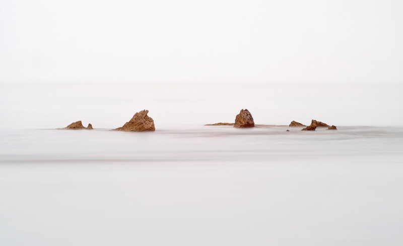 in a row, sea, animal wildlife, outdoors, ocean, studio shot, day, rock, no people, longexpo, simplicity, minimalism, movement, tranquility, background