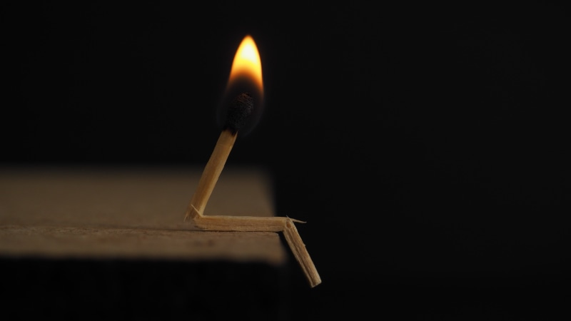 candle, single object, fire - natural phenomenon, nature, fire, no people, match - lighting equipment, flame, black background, indoors, wood - material