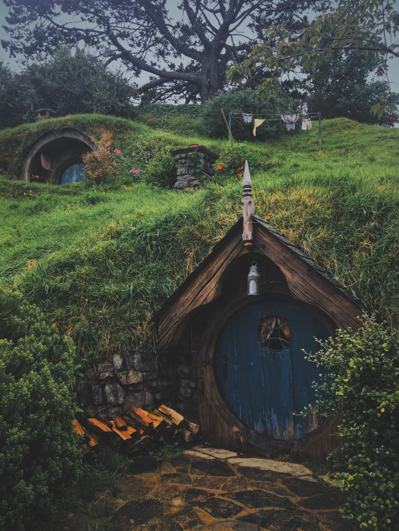 day, arch, hobbiton, hobbit hole, tree, built structure, brown, round door, grass, architecture, no people, green color, land, old, building, abandoned