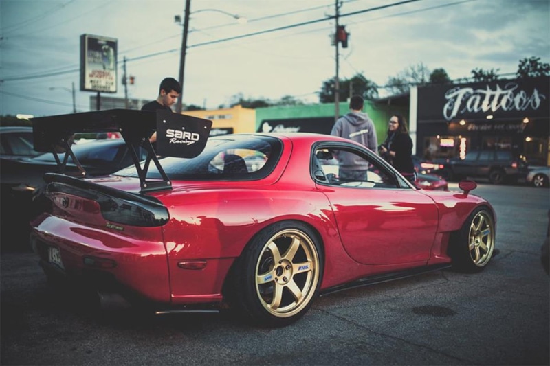 street, built structure, building exterior, real people, men, morning, evening, one person, red, drift, sports car, day, mode of transportation, transportation