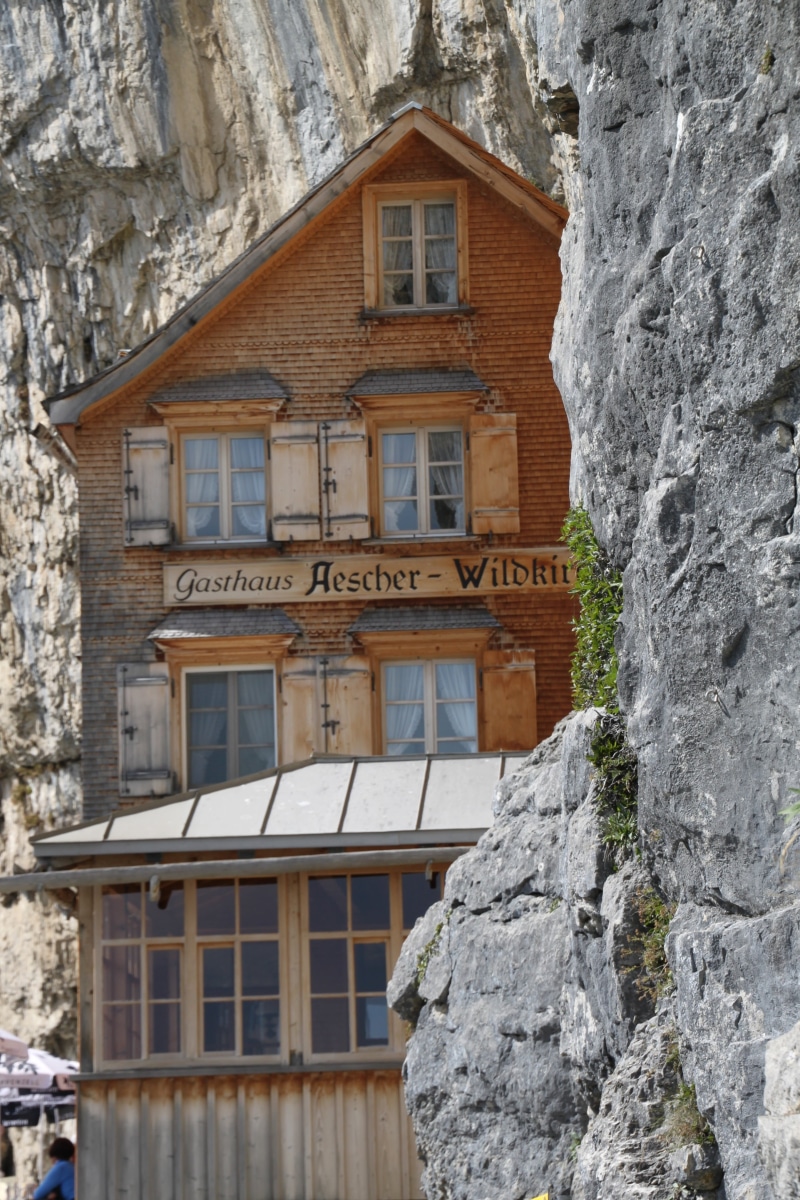 window, architecture, rock formation, solid, building exterior, outdoors, exposed, mountain station, no people, äscher cliff restaurant, day, romantic