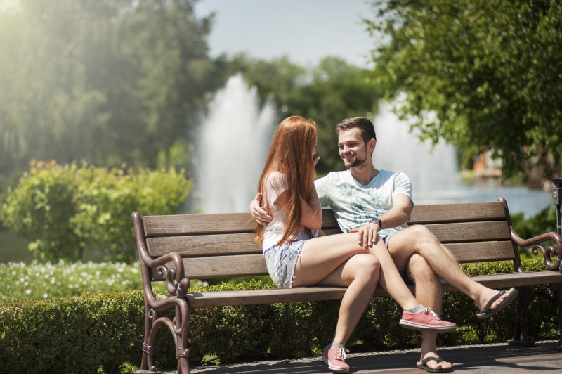 boyfriend, talking, positive emotion, nature, young couple, romance, emotion, flirting, leisure, laughing, young adult, 4K, full length, wooden bench