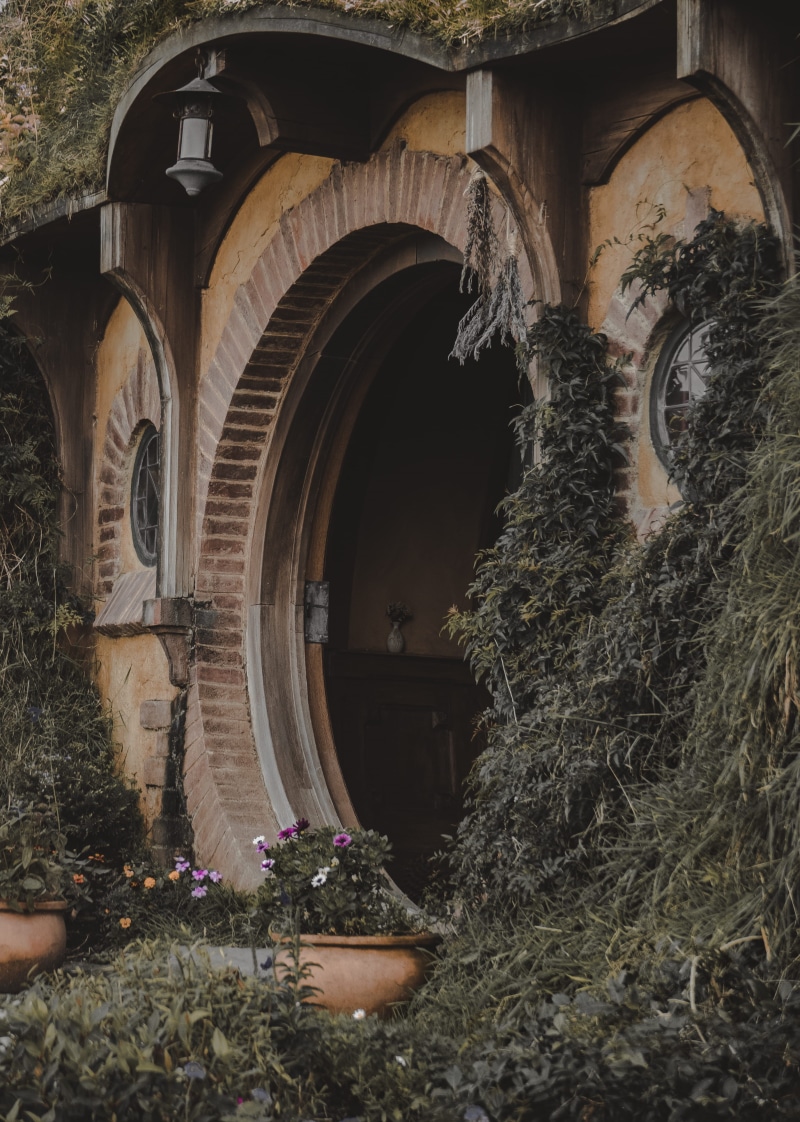arched, outdoors, hobbit, home, vase, house, production, day, beside, building exterior, creativity, lamp, old, flower, lord of the rings, concrete, pot
