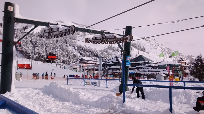 snowcapped mountain, architecture, built structure, warm clothing, group of people, snow, sky, winter, day, ski center, outdoors, 2K, winter sport, incidental people