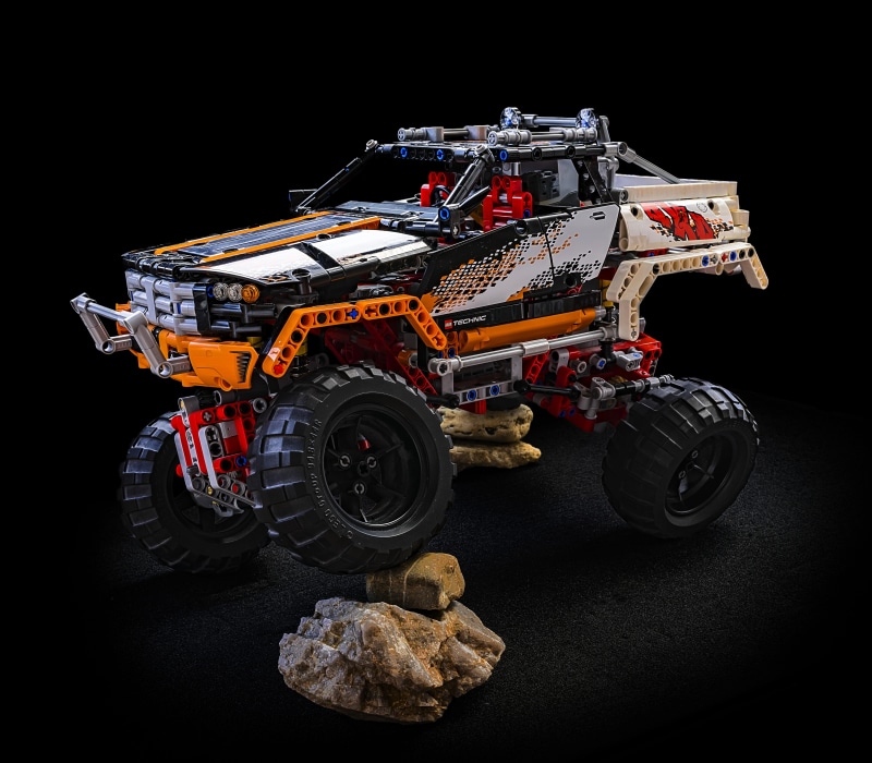 load area, truck, terrain, mode of transportation, black background, land vehicle, studio shot, transportation, outdoor, model, monster truck, no people