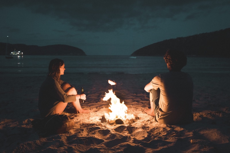 fire - natural phenomenon, relax, water, beach bonfire, seaside, trip, campfire, fire, holiday, dating, 4K, young adult, seashore, vibe, sitting by fire