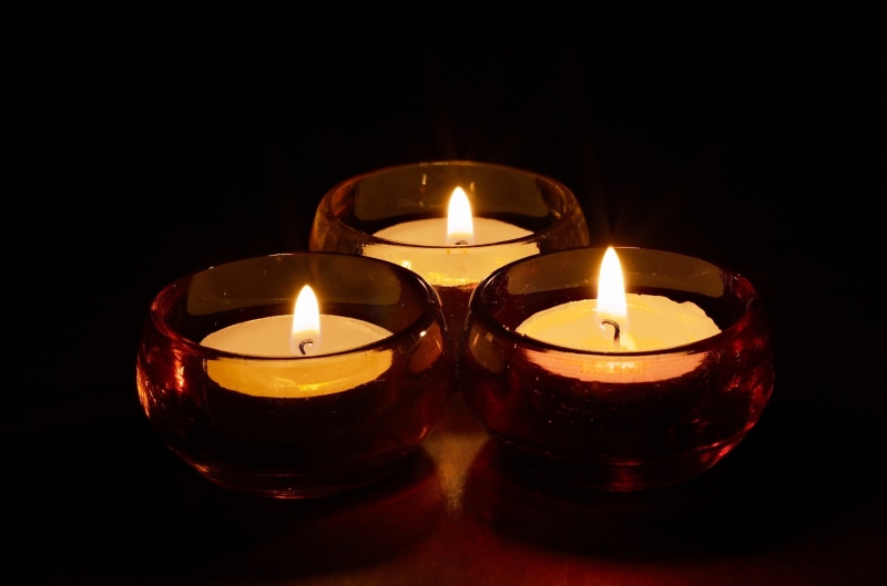 black background, tealight, decoration, fire, copy space, lighted, 2K, luminosity, glass, dark, heat - temperature, no people, candle, illuminated, lighting equipment