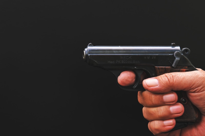 guns, holding, studio shot, human body part, black background, aiming, sign, one person, aggression, human hand, weapon, crime, various, gun, weapons, social issues