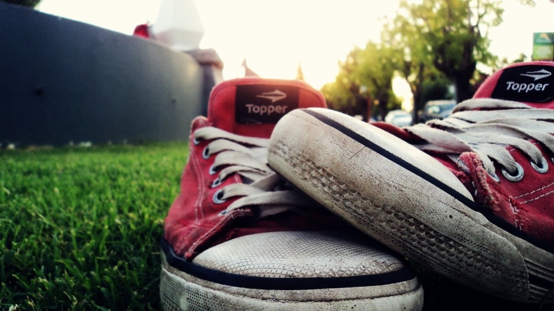 shoe, pair, surface level, sunlight, field, one person, low, top, shoes, canvas shoe, white, selective focus, day, sport, focus on foreground, outdoors