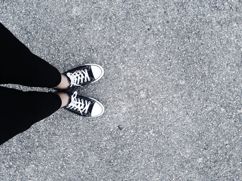 wearing, person, one person, hipster, pants, top, limb, low section, black pants, women, city, human foot, sneakers, body part, human limb, outdoors, human leg