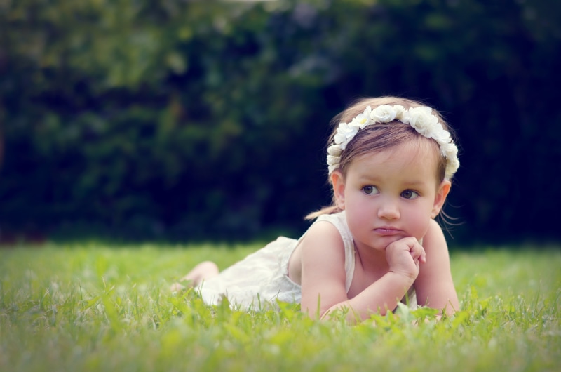 children, little girl, lying on front, hair, plant, front view, baby, young, outdoors, 4K, selective focus, day, babyhood, nature, innocence, looking