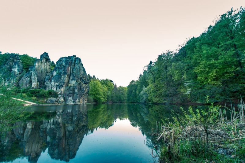 germanic, symmetry, tranquil scene, popular, culture, sanctuary, teutoburg forest, sandstone rocks, waterfront, non-urban scene, stone, water, sky, body
